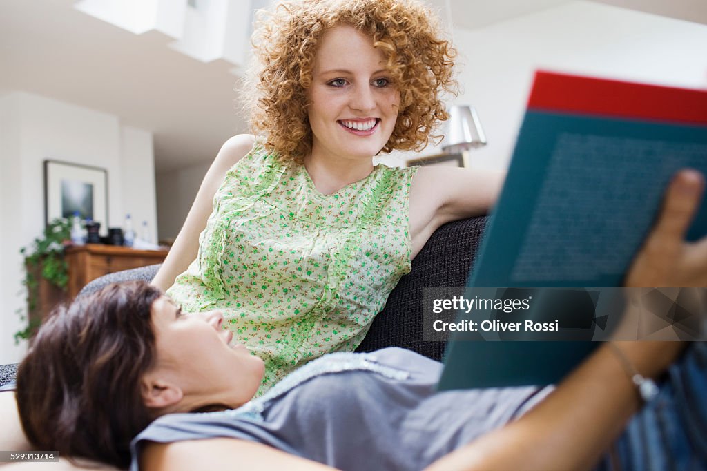 Friends studying together on sofa