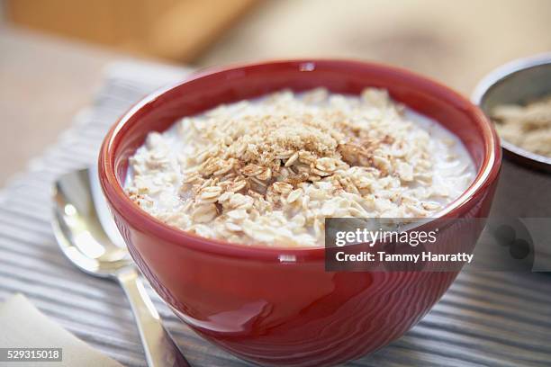 oatmeal in bowl - oatmeal stock pictures, royalty-free photos & images