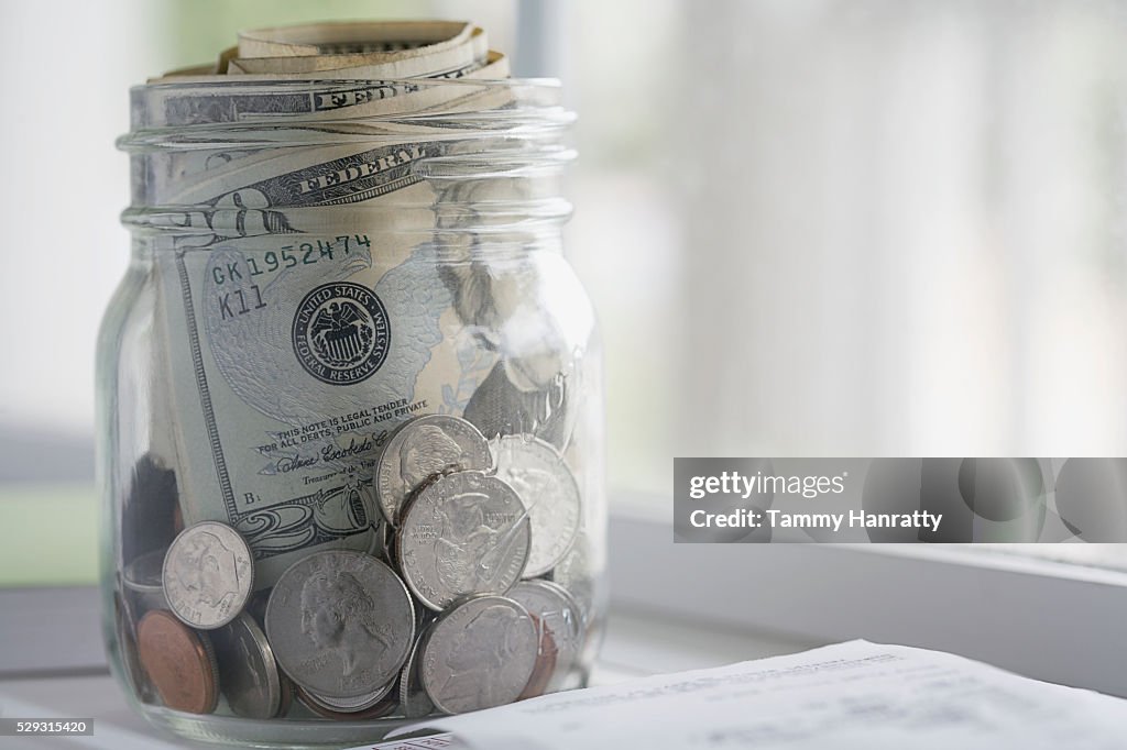 Glass jar full of cash