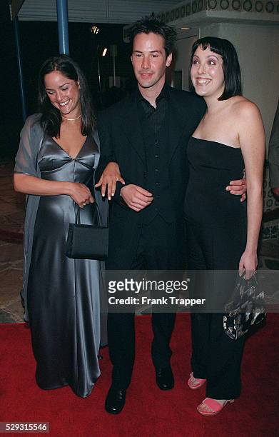 Keanu Reeves arrives with his sisters.