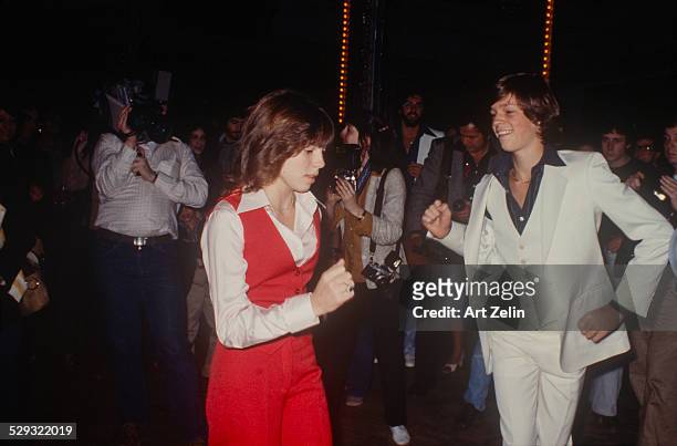 Jimmy McNichol dancing with his sister Kristy McNichol photographers in the background; circa 1970; New York.