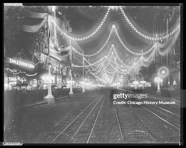 Night view of the dedication of the World's Columbian Exposition world's fair on State Street, Chicago, Illinois, 1892.