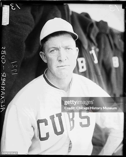 Chicago Cubs baseball player Grover Cleveland Alexander sitting in a dugout at Weeghman Park, Chicago, Illinois, 1921. Weeghman Park was renamed...