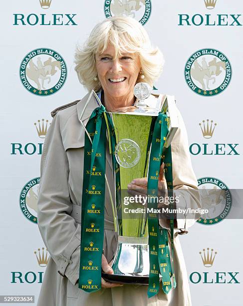 Camilla, Duchess of Cornwall holds the Rolex Grand Slam of Eventing Trophy before presenting it to Michael Jung after he won the Badminton Horse...
