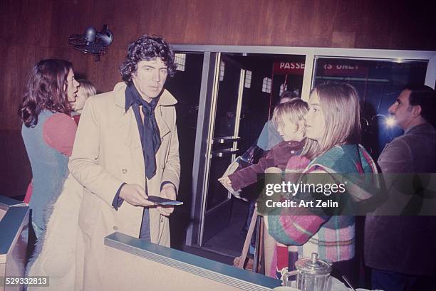 Alan Bates with his wife Victoria Ward and his twin sons Benedick and Tristan at a terminal gate; circa 1970; New York.