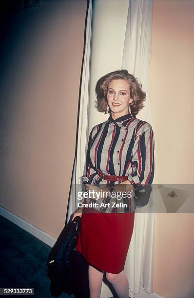 Diane Lane wearing a striped tunic and red skirt; circa 1970; New York.