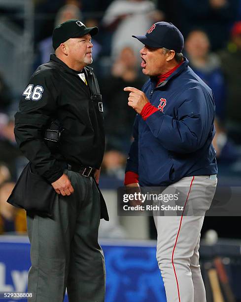 Manager John Farrell of the Boston Red Sox argues with home plate umpire Ron Kulpa after David Ortiz argued a called strike by home plate umpire Ron...