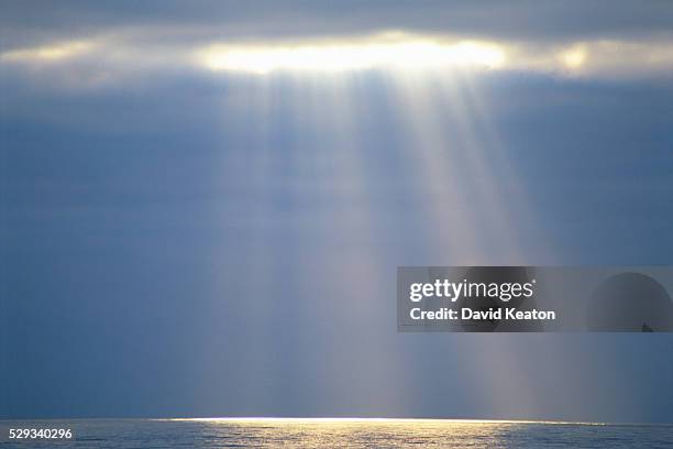 sunlight breaking through clouds - kearton stock pictures, royalty-free photos & images