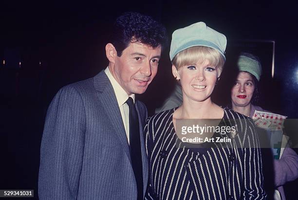 Connie Stevens with Eddie Fisher. She is wearing a blue and white striped jacket; circa 1970; New York.