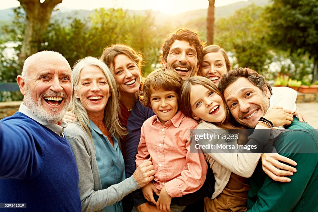 Cheerful multi-generation family at yard