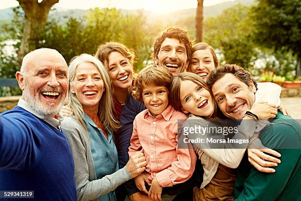 cheerful multi-generation family at yard - familia fotografías e imágenes de stock
