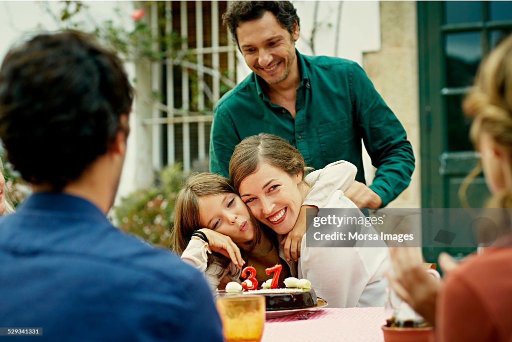 Happy family celebrating birthday in yard