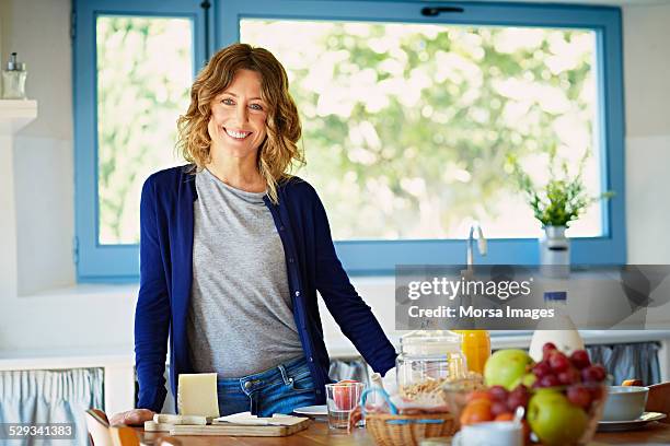 happy woman at breakfast table in kitchen - fruit stand stock pictures, royalty-free photos & images