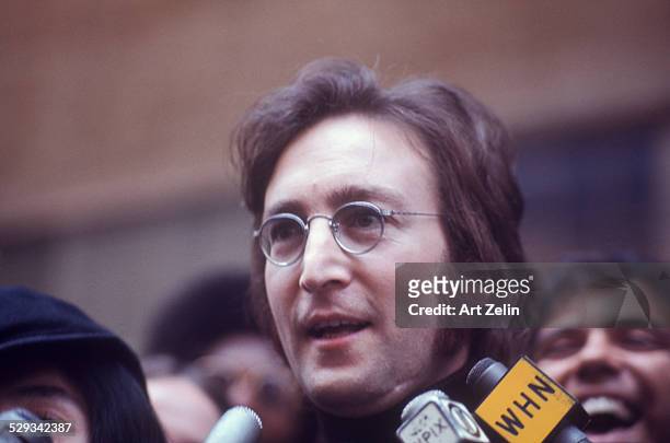 John Lennon being interviewed on the street.; circa 1970; New York.