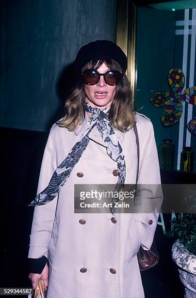 Julie Christie in a gray trench coat and sunglasses; circa 1970; New York.
