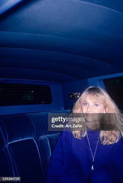 Rosanna Arquette wearing blue in a limousine; circa 1970; New York.