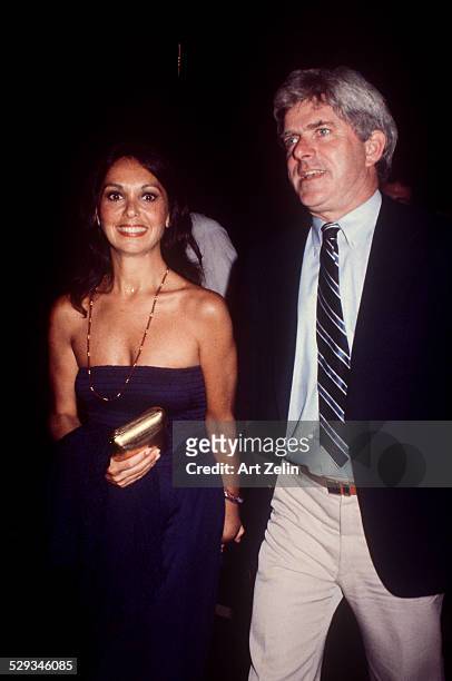 Phil Donahue with his wife Marlo Thomas he is wearing a shirt and tie she is in a blue strapless; circa 1970; New York.