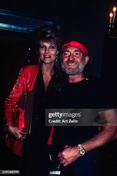 Willie Nelson with his wife Connie Keopke. She is wearing a red sequined jacket; circa 1970; New York.