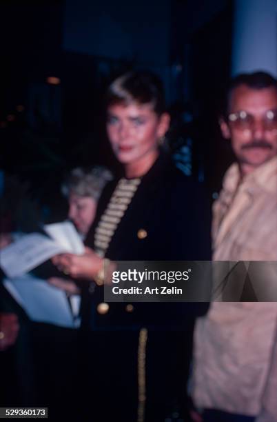 Margaux Hemingway wearing a cropped jacket with gold buttons; circa 1970; New York.