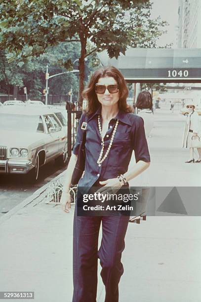 Jacqueline Kennedy Onassis walking down the streets of New York; circa 1970; New York.