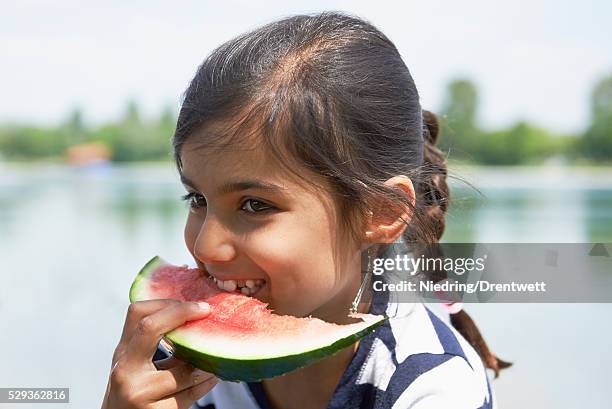 girl enjoying slice of watermelon at picnic, munich, bavaria, germany - bavaria girl stockfoto's en -beelden