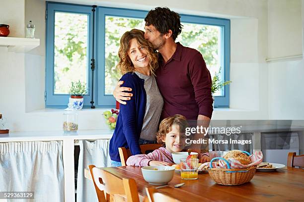 loving family at breakfast table in kitchen - 40 49 years stock pictures, royalty-free photos & images