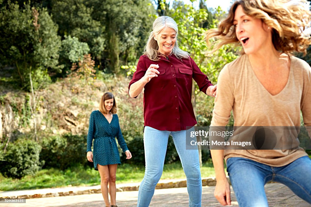 Mother and daughters playing at park