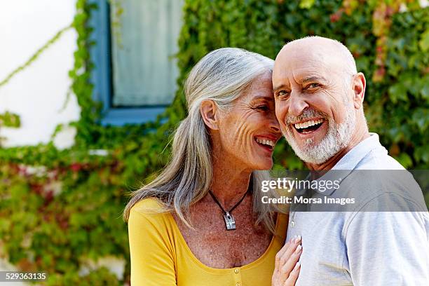 happy senior man with woman at yard - provincie barcelona stockfoto's en -beelden