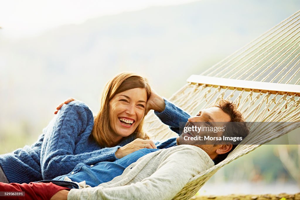 Happy couple relaxing on hammock