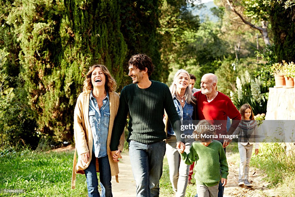 Happy family walking in park