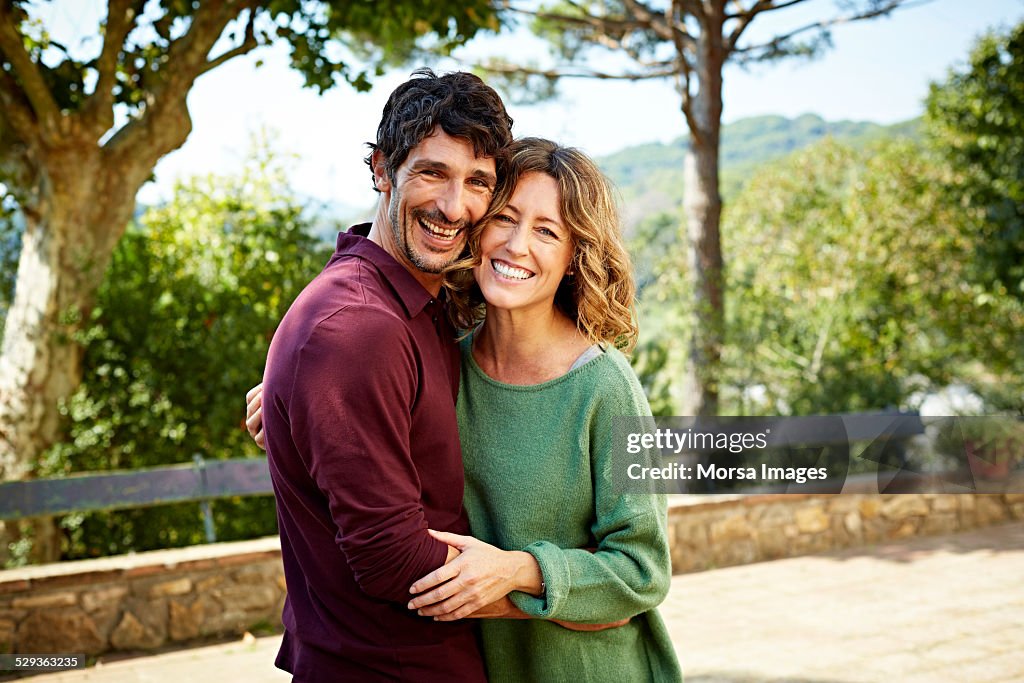 Happy couple embracing in park