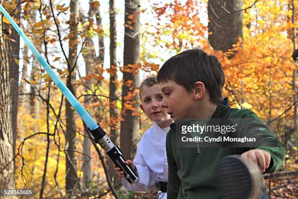 two boys playing imaginary games - light sword stock pictures, royalty-free photos & images
