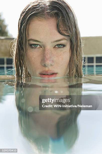 woman swimming in a swimming pool - face symmetry stock pictures, royalty-free photos & images
