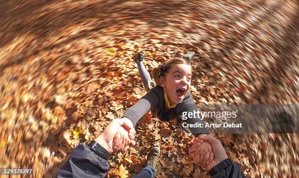 smiling girl spinning and holding dad's hands - non moving activity bildbanksfoton och bilder