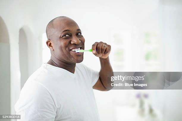 man brushing teeth, smiling - teeth cleaning stock pictures, royalty-free photos & images