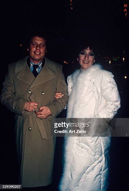 Joyce DeWitt in a white fur trimmed down coat with a friend; circa 1970; New York.