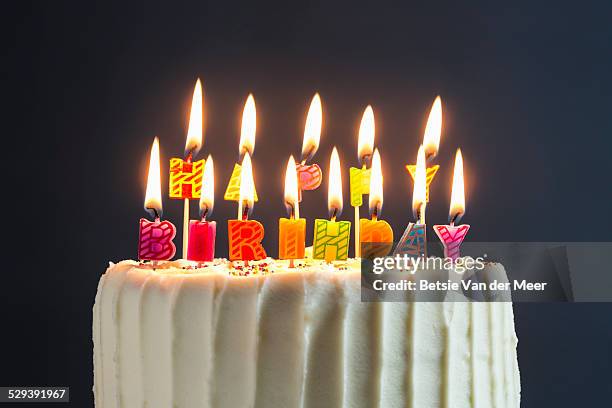 still life of cake with happy birthday candles. - birthday candle on black stock pictures, royalty-free photos & images