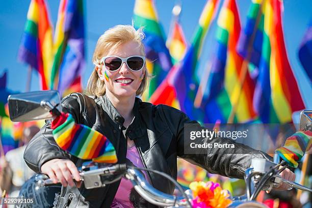 woman riding motorcycle during gay parade - gay leather stock pictures, royalty-free photos & images
