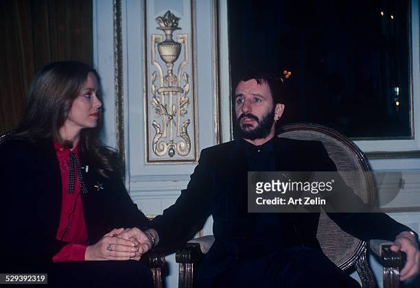 Ringo Starr with his wife Barbara Bach miked for an interview. They are holding hands; circa 1970; New York.