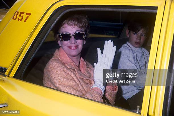 Eve Arden with her son Douglas Brooks West in taxi. Circa 1949; New York.