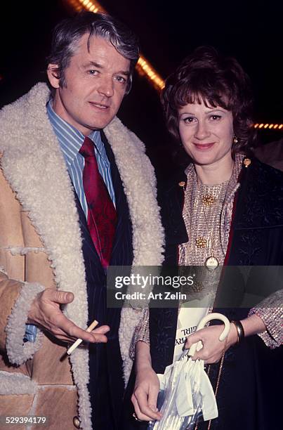 Dixie Carter with her husband Hal Holbrooke. She is carrying an umbrella and he is wearing a shearling jacket; circa 1970; New York.