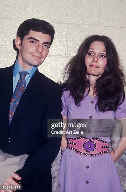 Paula Prentiss with her husband Richard Benjamin. She is wearing a purple dress and carrying her fur coat; circa 1970; New York.