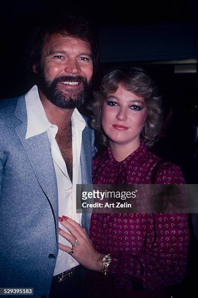 Tanya Tucker with Glenn Campbell. She is wearing a fuchsia paisley blouse; circa 1970; New York.