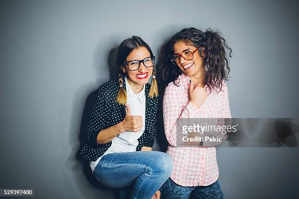 two nerdy best friends giggling - nerdy latina stock pictures, royalty-free photos & images