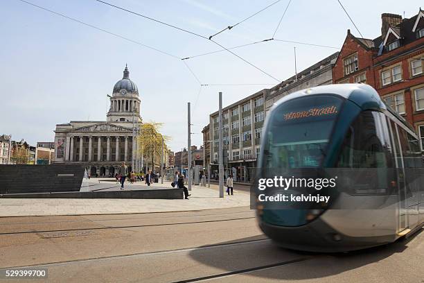 tram passing nottingham council house in the old market square - nottingham market square stock pictures, royalty-free photos & images