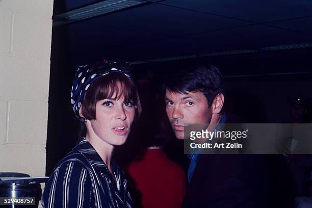 Gary Lockwood with his wife Stefanie Powers. She is wearing a navy and white striped jacket and scarf; circa 1970; New York.