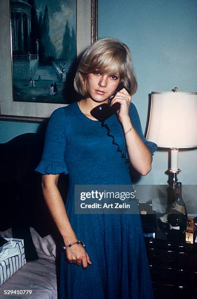 Sylvie Vartan as a teenager taken in a hotel room. She is talking on the phone; circa 1970; New York.