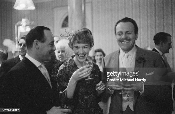 Terry-Thomas shares a joke with British speed record breaker Donald Campbell and singer Tonia Bern during their wedding reception, Caxton Hall,...