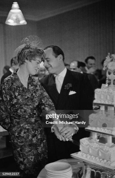 British speed record breaker Donald Campbell and singer Tonia Bern cut the cake during their wedding reception at Caxton Hall, London, 24th December...