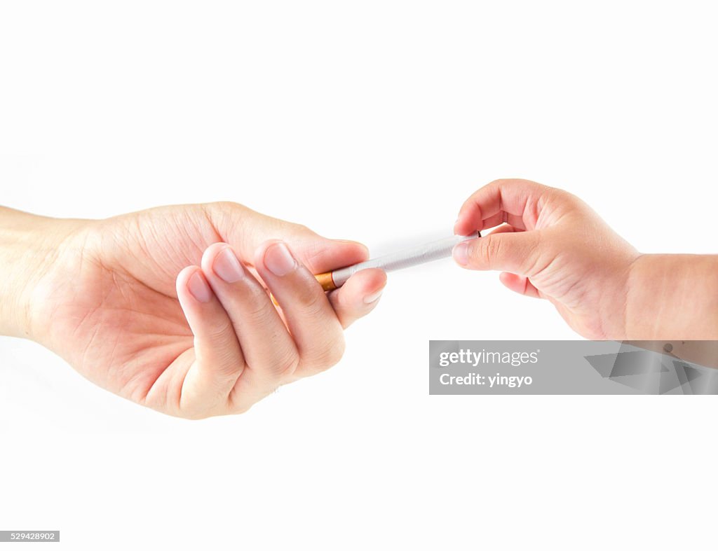 Adult and children's hands holding a cigarette.